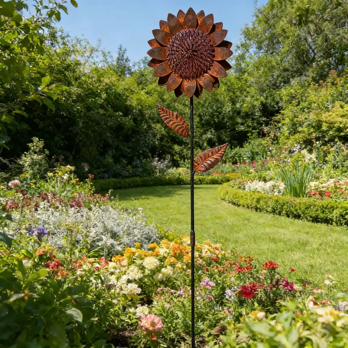 Rustic sunflower garden stake in a flower border